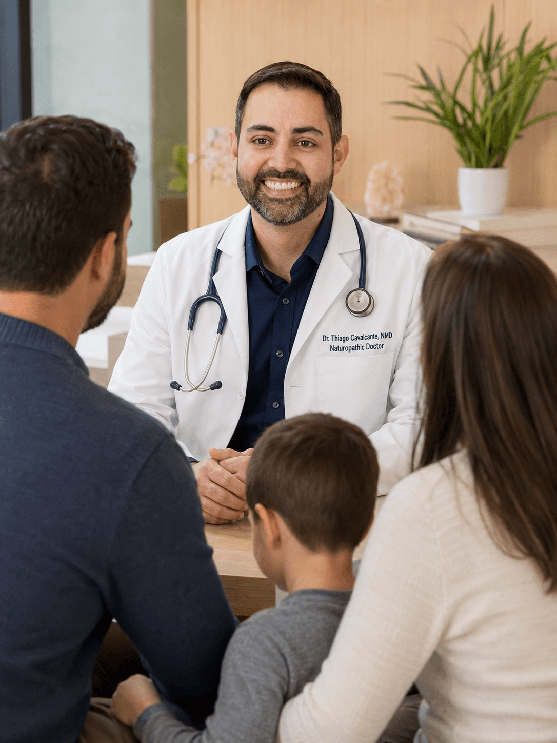 Dr. Thiago Cavalcante in a naturopathic pediatric consultation with a family of four